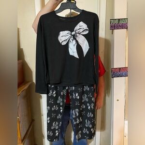 Black pajama top with silver/white bows all over and very soft bottoms with bows
